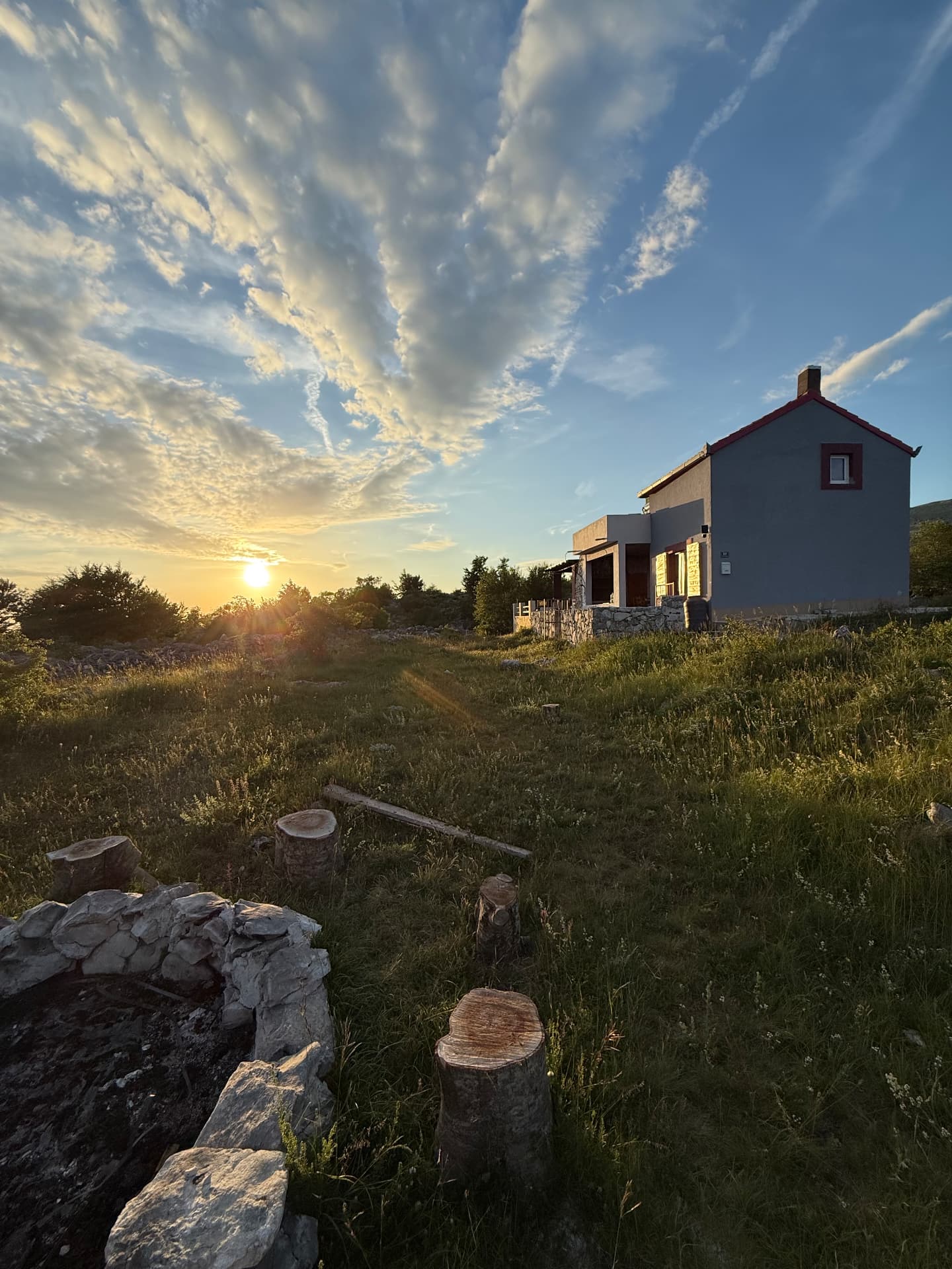 The Svilaja Tribe mountain house and fire pit at sunset